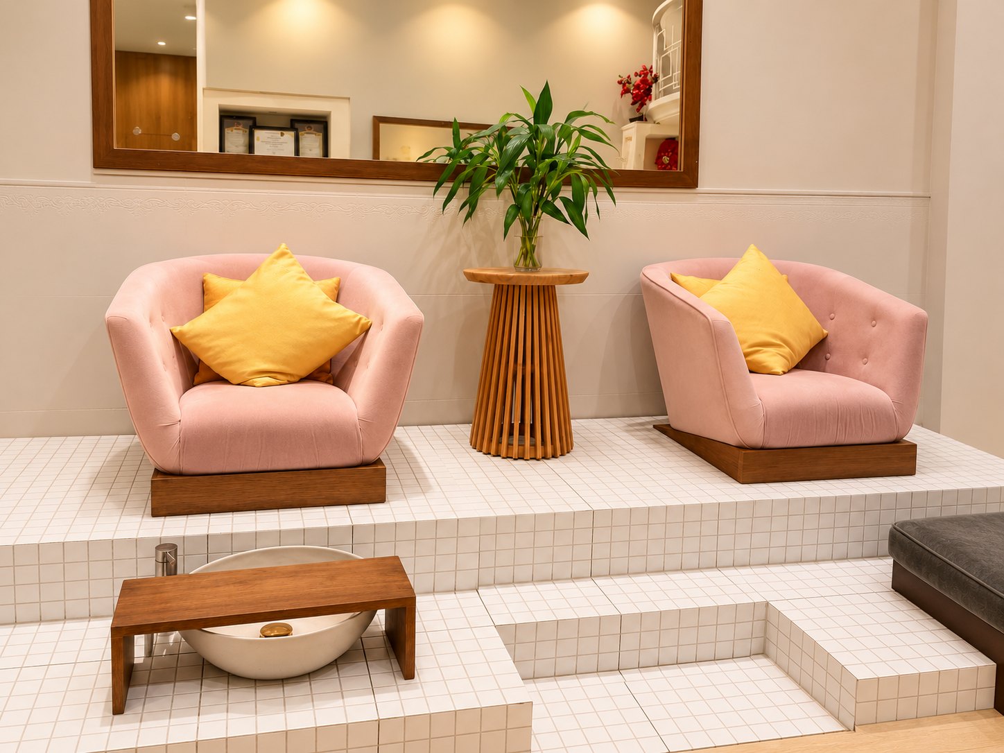Blush armchairs and golden cushions, ready for your pedicure.